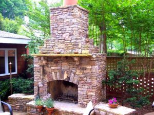 Installation of outdoor stone fireplace design in Charlotte, NC by Charlotte Pavers & Stone.